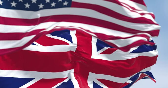National flag of the Unites States and United Kingdom waving in the wind