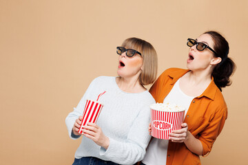 Elder amazed parent mom with young adult two women together wear casual clothes 3d glasses watch...