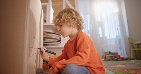A Creative Child Drawing on a Wall in a Cozy Room that Radiates Joy and Exploration