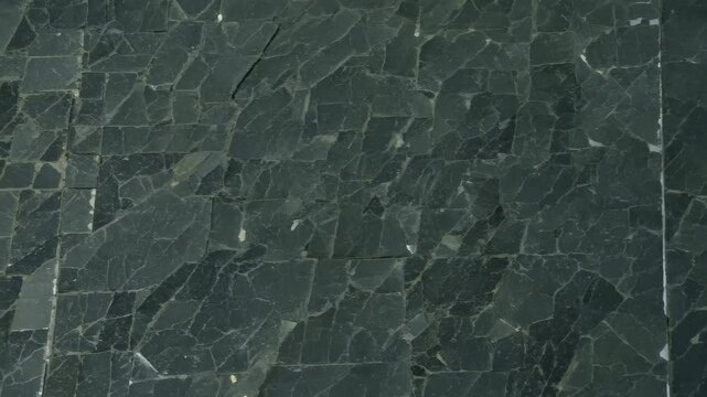 Close-up of textured green marble stone surface with elegant patterns.