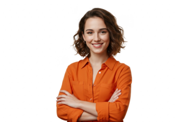 A young woman with short wavy brown hair wearing an orange shirt isolated stands with her arms crossed on transparent background