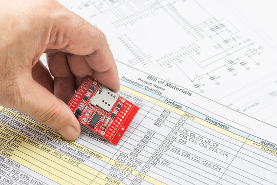 Electronics technician assembling components on bill of materials for circuit board