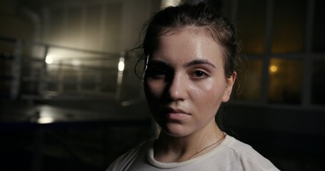 A Striking Intense Boxing Portrait Set in a Dimly Lit Gym Environment, Capturing the Spirit