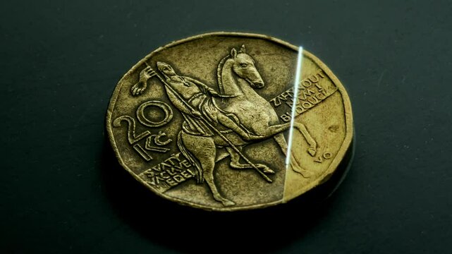 A 4K video showing a laser cleaning the surface of a 20 CZK coin, removing dirt and revealing fine details. Captured at 60fps, ideal for close-up, technology, and laser applications. Macro shot.