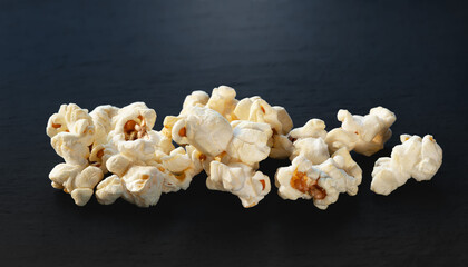 Popcorn. Pile of popcorn on dark