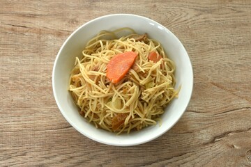 fried vegetarian Chinese yellow rice noodles with cabbage and carrot on bowl
