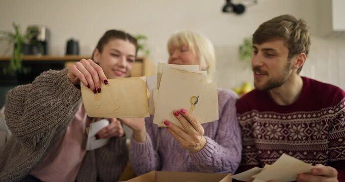 Family enjoys a heartfelt moment while discovering old photos together at home