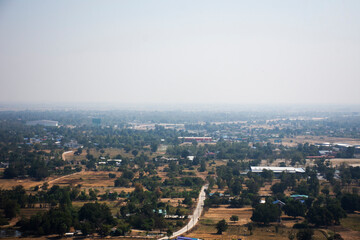 Obraz premium Aerial view landscape of rice field or paddy land and village countryside from viewpoint of Wat Khao Meng Amornmet Temple for thai people travelers travel visit at Pak Phraek in Kanchanaburi, Thailand