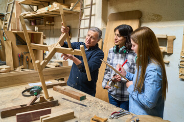 Mentorship and teamwork in a busy carpentry workshop
