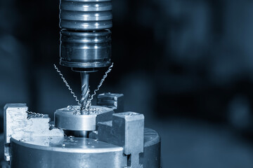 Close up scene the tapping process on CNC milling machine with tapping holder in the light blue...