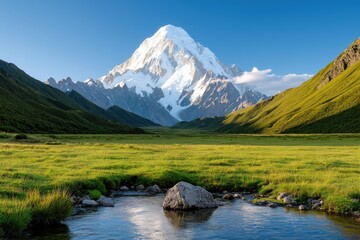 Naklejka premium Majestic mountain landscape with a clear blue sky and green valley.