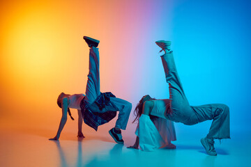 Dynamic image of female dancers moving in sync to hip hop beats against glowing neon gradient...
