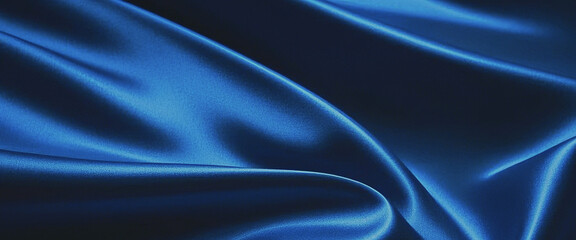 Obraz premium A dark blue abstract background with shiny fabric and wavy pleats, featuring copy space for design