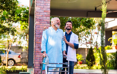 Elderly Indian patient with a walker walks with a doctor in a hospital garden, discussing health