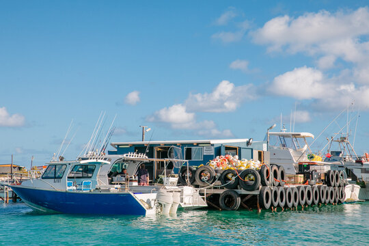 Cray boats alongside an old wooden jetty with fishing shacks