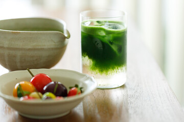 Cup of fresh matcha tea, green tea and colorful peach fruit shape Plating balls, Thailand style...
