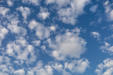 bright blue sky with scattered fluffy white clouds