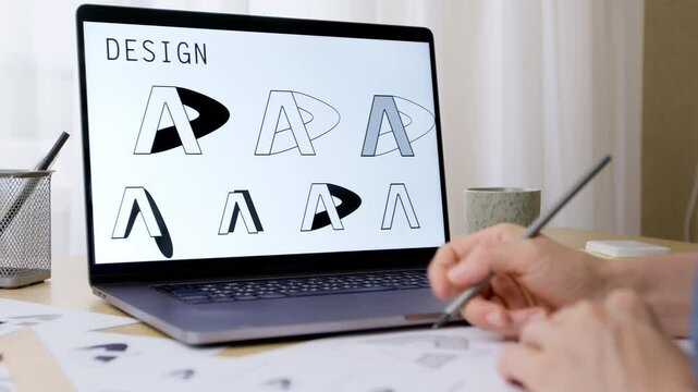Creating a logo sketch using a computer. A female designer working on a branding project on a laptop.