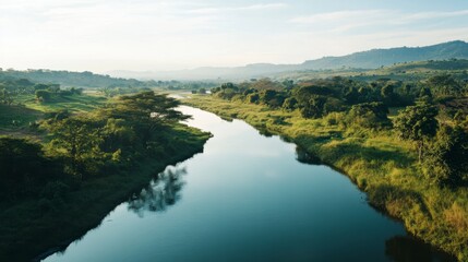 Obraz premium Serene River Surrounded by Lush Greenery and Rolling Hills