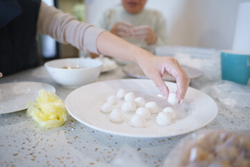 Asian mother and daughter cooking Banh Troi Nuoc in Cold Food festival