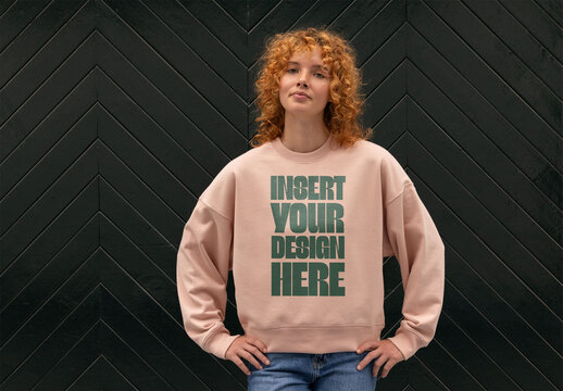 Redhead Woman in Stylish Sweater Poses Against Dark Background. PSD ready to customize with your design