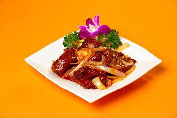 Chinese Beef Tenderloin with onion served in plate isolated on orange background side view of hong kong food