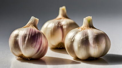 Obraz premium Close-up of four fresh, plump garlic cloves isolated on a white background
