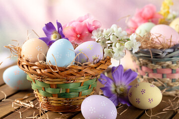 Easter eggs and flowers in a basket with colorful springtime background