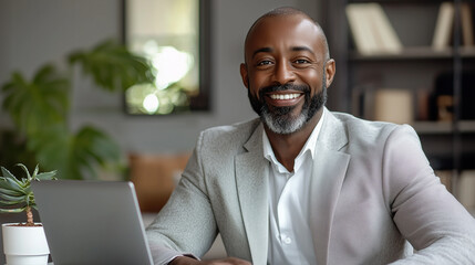 Happy Successful Black Businessman Working on Laptop in Modern Office