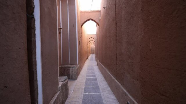 Walking around the old city of Yazd. Yazd is an old Persian city. The streets of the old clay city of Yazd in Iran. Old town Yazd is listed as a UNESCO World Heritage site. Slow motion video. 
