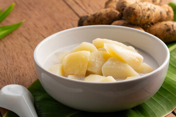 Coconut Milk Stewed yam (D. esculenta(Lour.) Burkill),Thai dessert boiled sliced Dioscorea esculenta yam in coconut milk with sugar in white bowl.