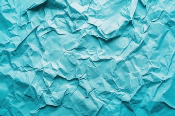 Obraz premium Blue wrinkled paper texture with creases and folds.