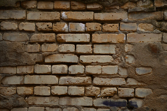 Old weathered brick wall texture background, rustic damaged masonry pattern