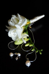 Elegant Corsage with White Flowers and Pearls on a Dark Background..
