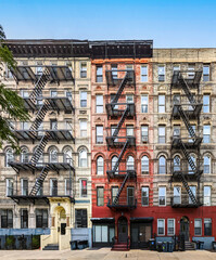 Exterior view of old apartment buildings with fire escapes in the East Village neighborhood of New...