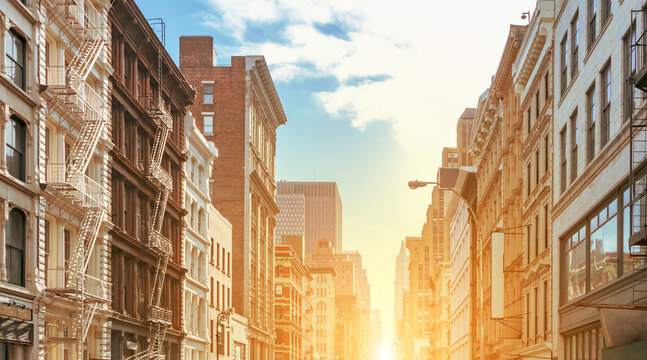 Sunlight shining behind the historic buildings on Broadway in the SoHo neighborhood of Manhattan in New York City