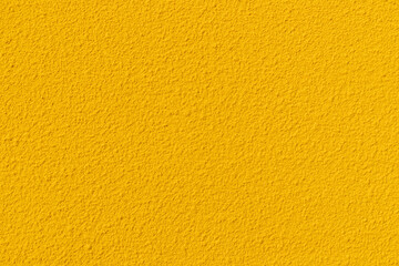 Cement textured yellow wall background texture