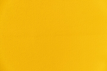 Cement textured yellow wall background texture