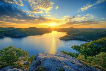 Photograph of the Swedish archipelago, view from the top of a rock overlooking a lake and forest landscape.