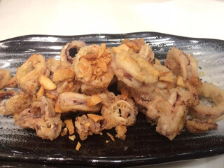 Crispy deep fried squid in black plate