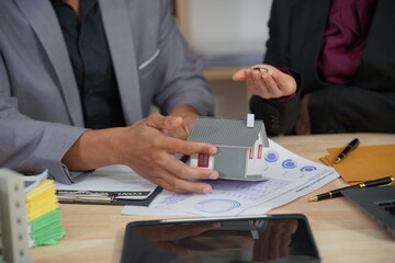 Fototapeta premium Close-up of businessman discussing contract with real estate agent for home insurance consultant Real Estate Investment