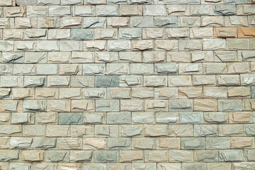 The exterior walls of the building are decorated with grey brick walls