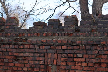 A damaged brick wall with a hole in it.