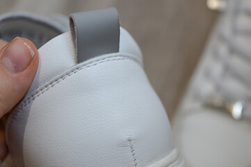 white sneaker with an elegant design high-quality stitching footwear shoe stores detail fashion...