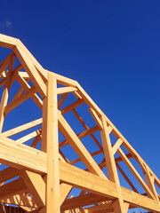 Obraz premium Wooden Roof Truss Construction Under Sunny Skies
