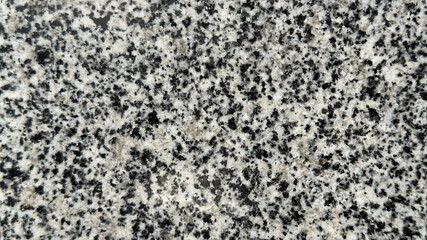 Texture of polished granite in black and white color close-up