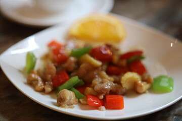 A white plate filled with a variety of meat and vegetables, perfect for a meal or snack.