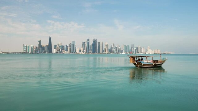 Traditional Arabic Dhow boats in Doha harbour, Qatar. beautiful seascape with sea and modern skyscrapers on the background.