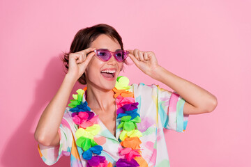 Photo of lovely young woman touch sunglass look empty space wear shirt isolated on pink color background