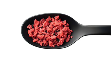 Png of Close-up of vibrant red rock salt crystals on a black spoon on transparent background.